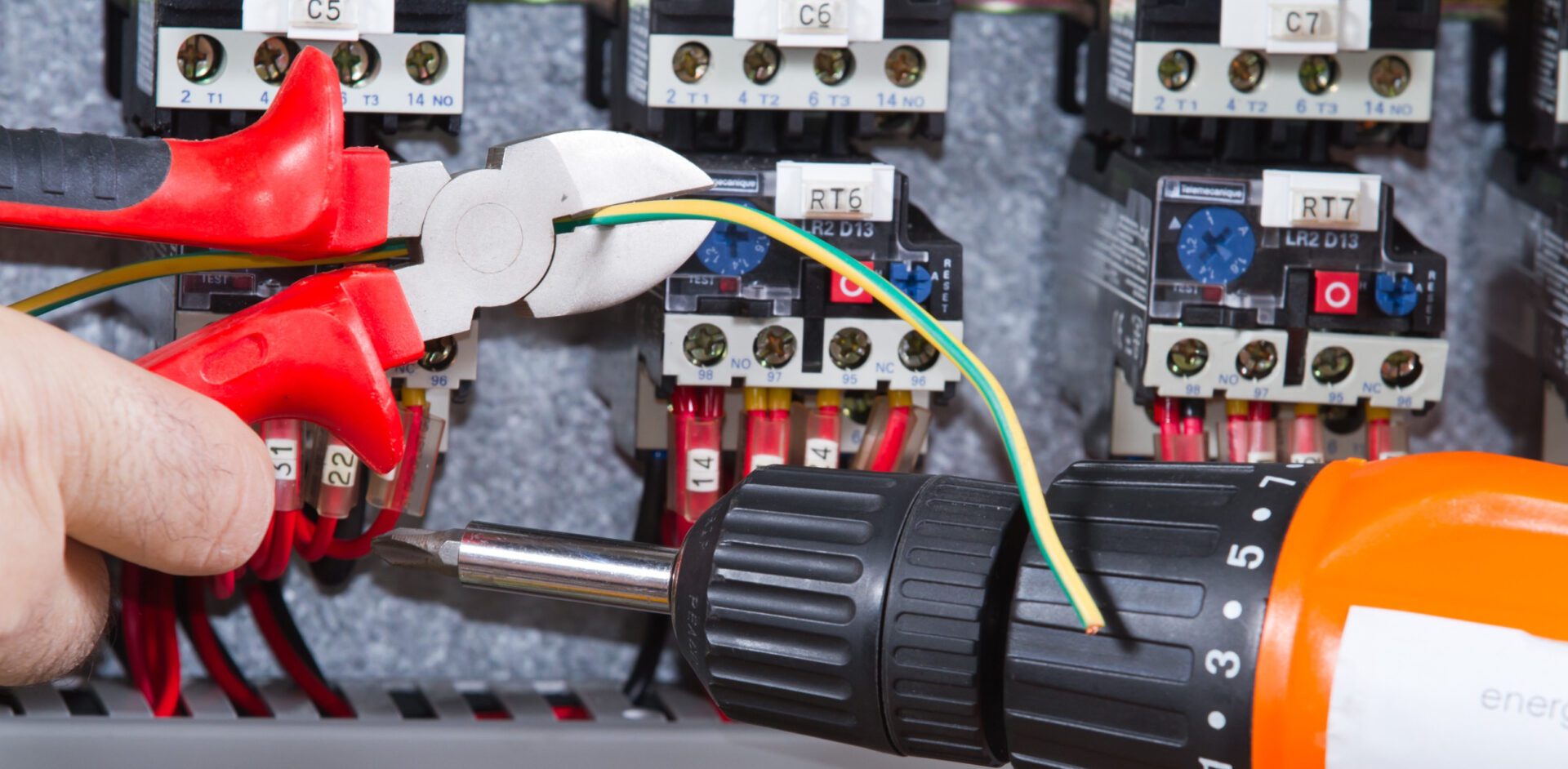 electrician at work with an electric panel<br />